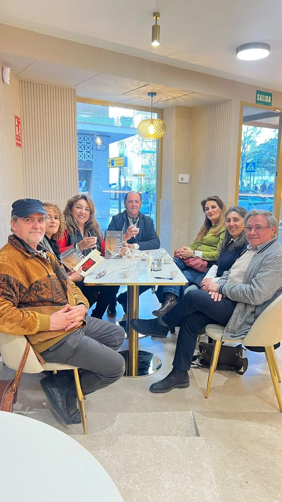 Un grupo de visitantes reunidos alrededor de una mesa en Le Katar